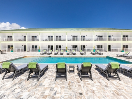 pool with lounge chairs and restaurant in background