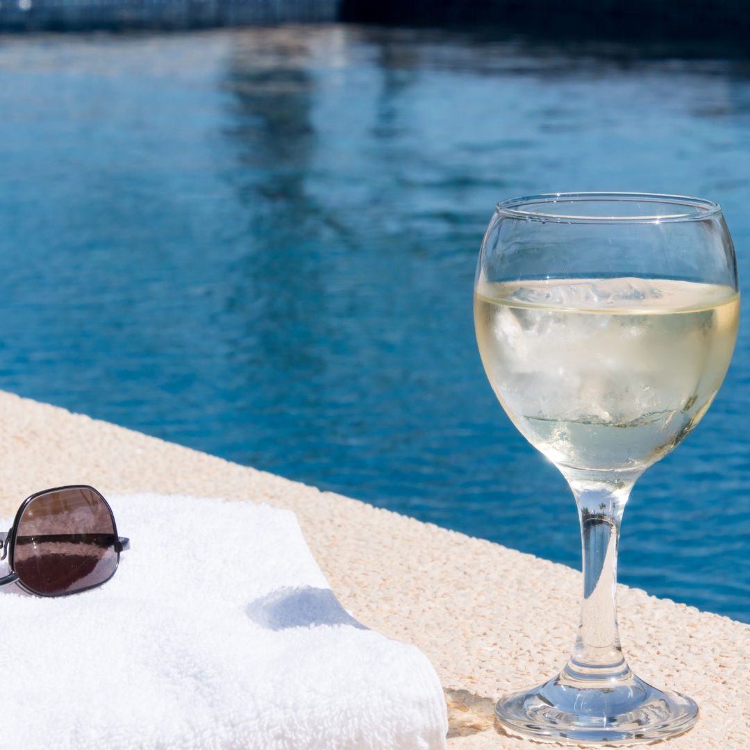 Poolside glass of wine and sunglasses