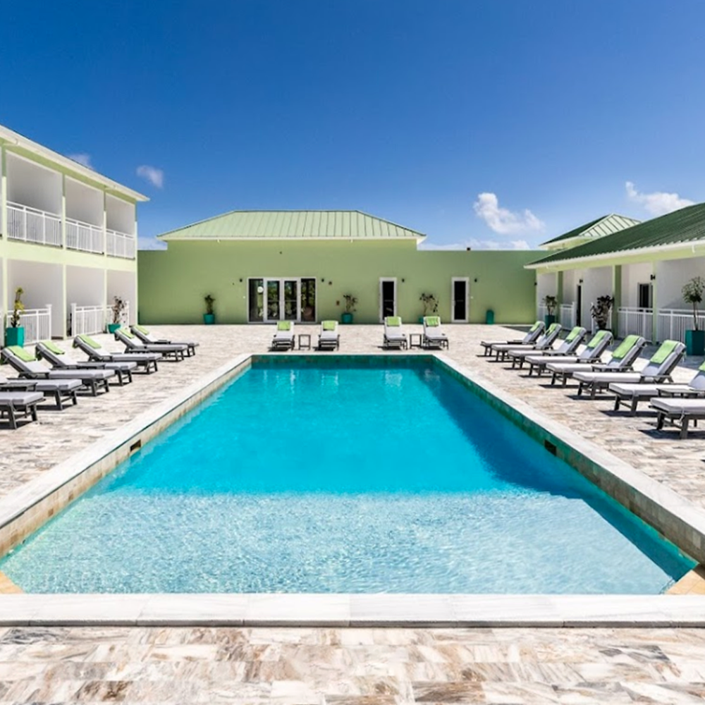 pool with lounge chairs and restaurant in background