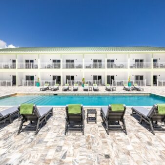 pool with lounge chairs and restaurant in background